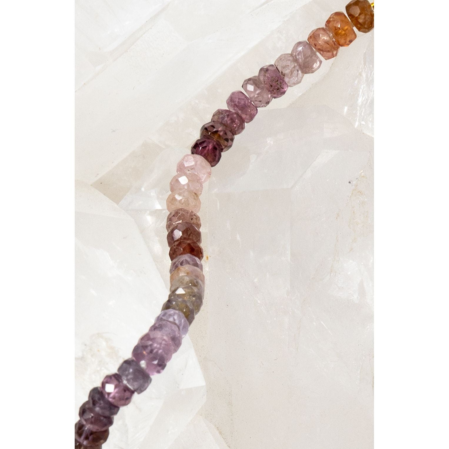 Close-up of the La Vie en Rose necklace showcasing multicolor spinel rondelles with natural variations in rose, blush, and earthy tones, highlighted along the strand.