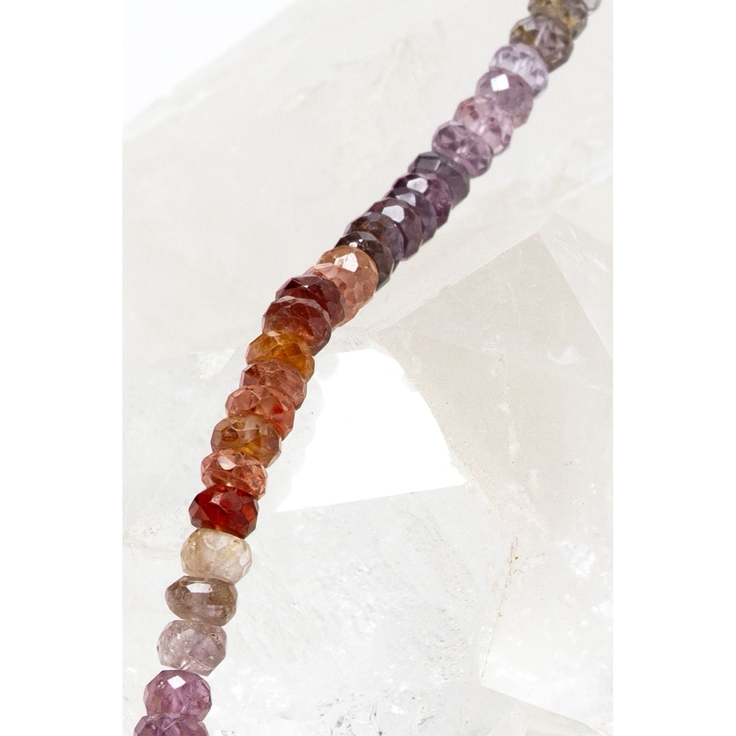 Close-up of the La Vie en Rose necklace highlighting faceted multicolor spinel rondelles, revealing their subtle brilliance, texture, and refined craftsmanship.