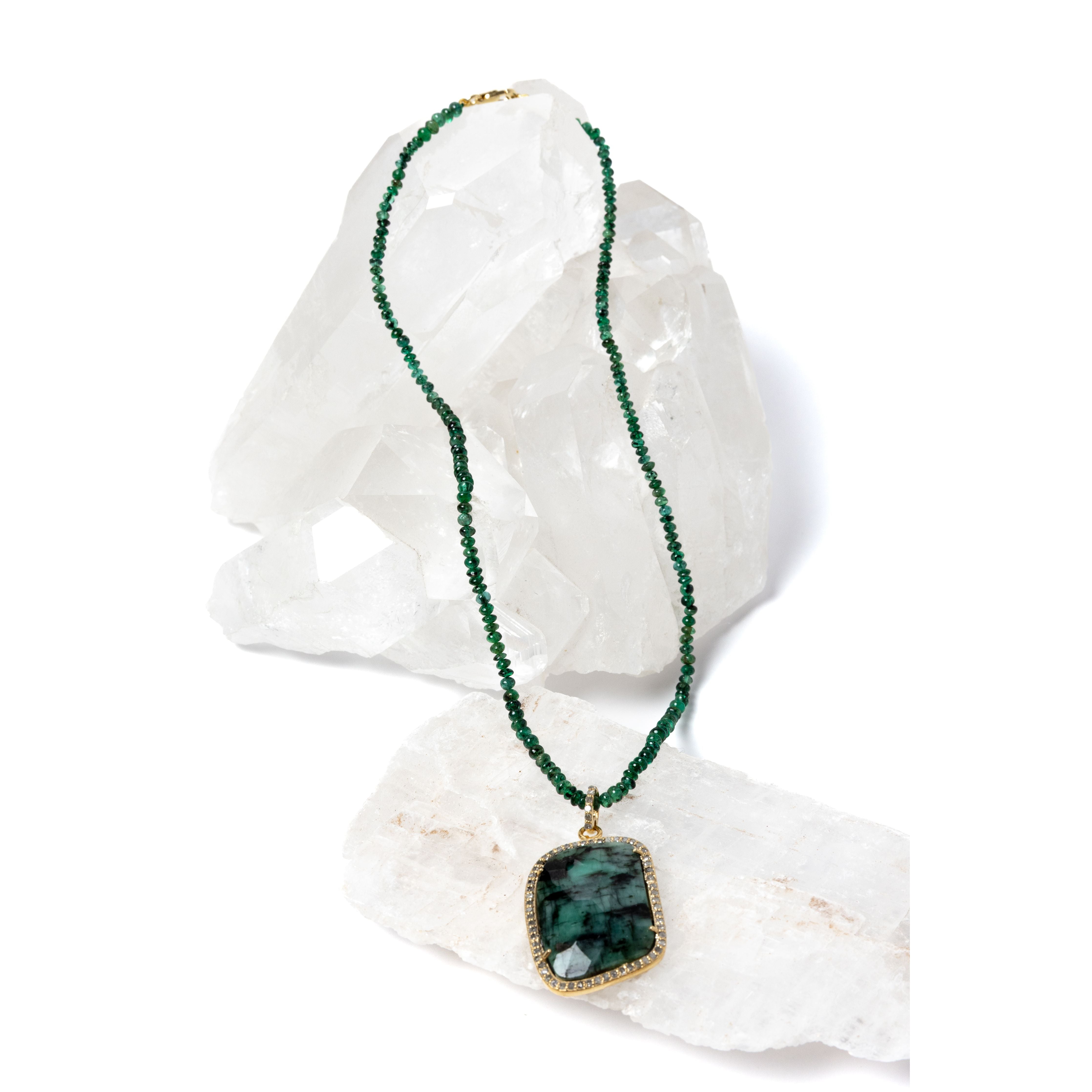 Emerald Wisdom necklace featuring beautifully faceted emerald rondelles with a statement emerald pendant, creating a rich interplay of depth, texture, and luminous green tones.
