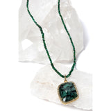 Close-up of the Emerald Wisdom necklace highlighting faceted emerald rondelles, revealing their natural depth, subtle brilliance, and richly saturated green tones.