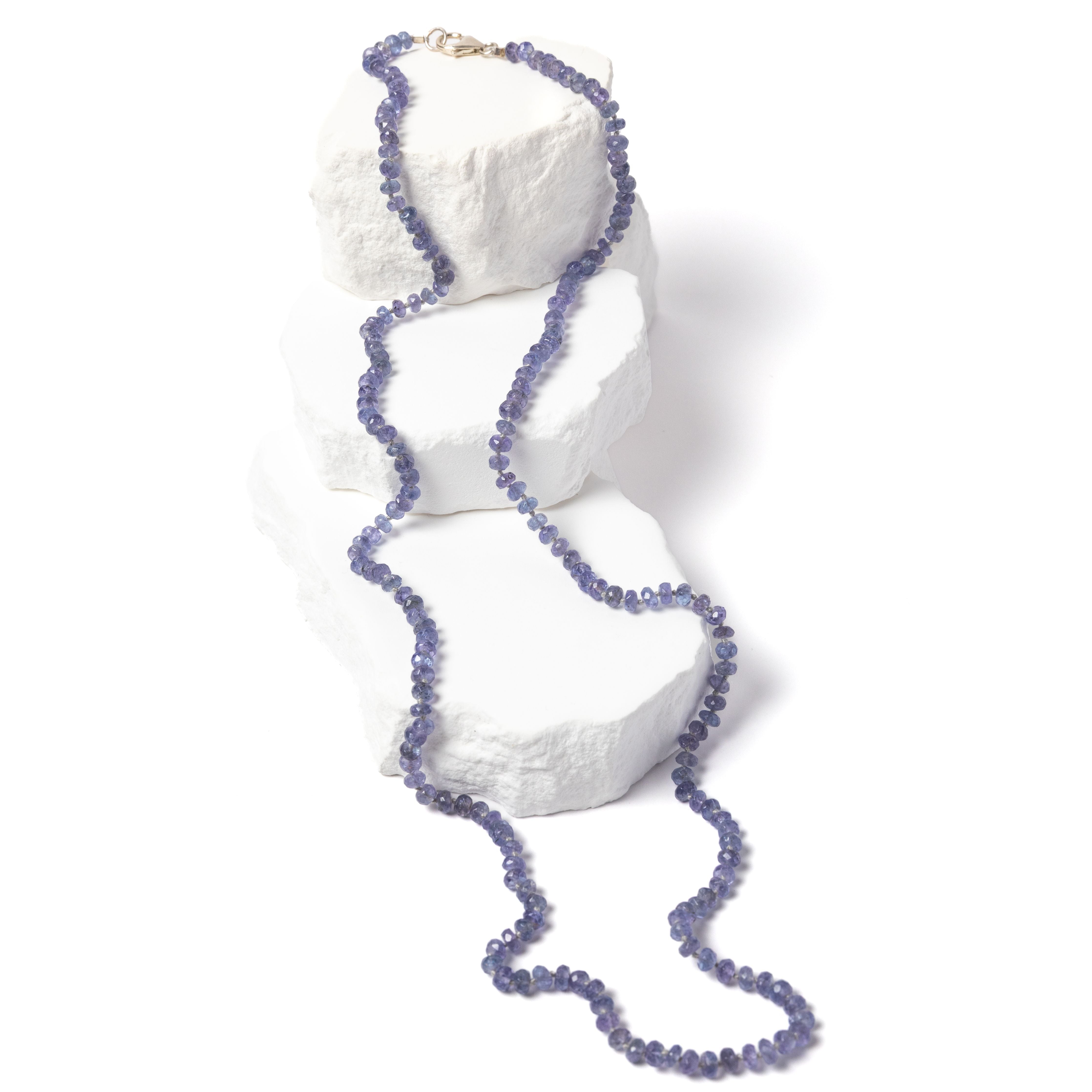 Misty Blue tanzanite necklace featuring approximately 85 carats of faceted rondelle gemstones in soft blue, lavender, and gray tones, individually knotted in a fluid 35-inch strand with a sterling silver clasp