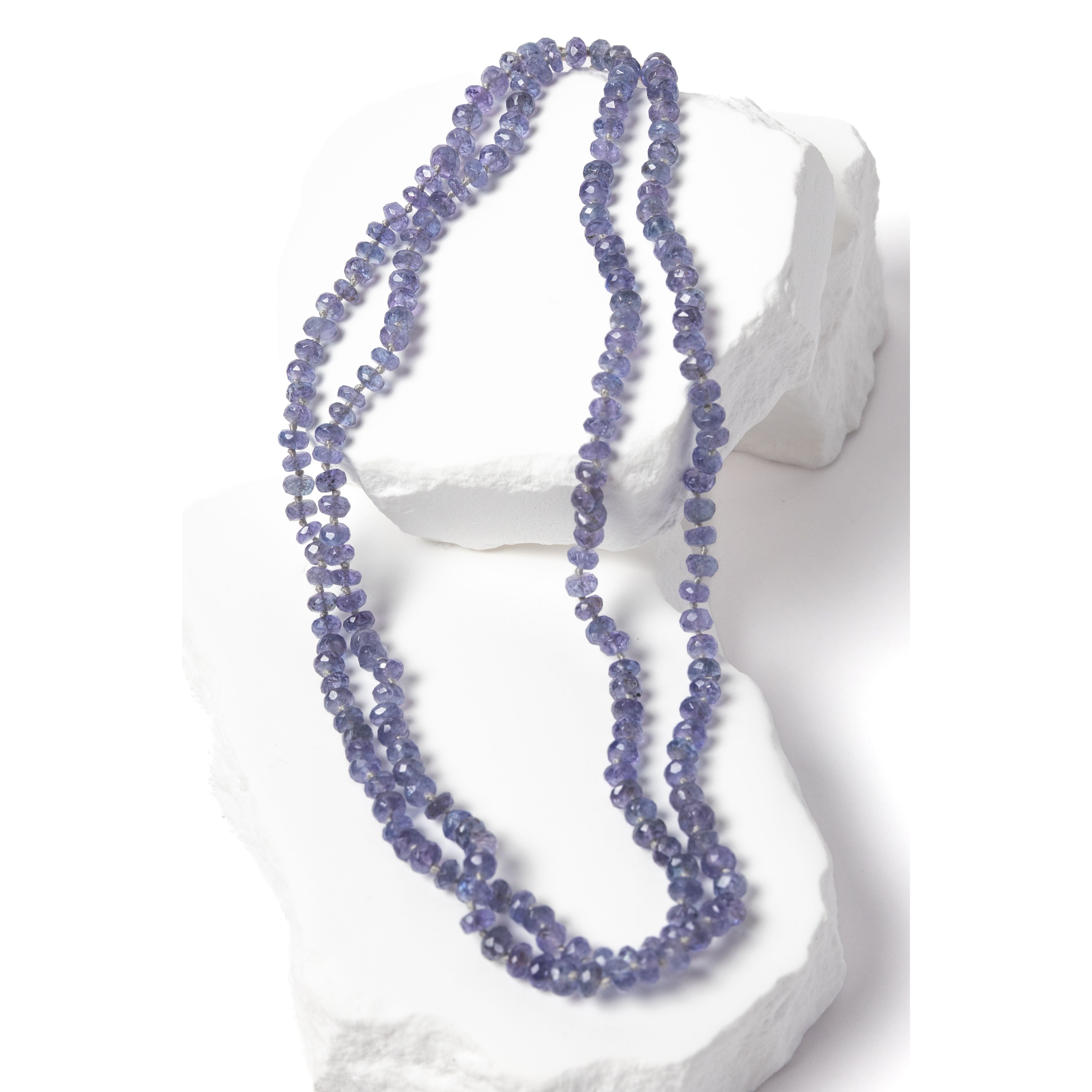 Tanzanite Misty Blue necklace styled as a double strand, highlighting its versatility and graceful drape, with individually knotted faceted rondelles creating a balanced, elegant silhouette