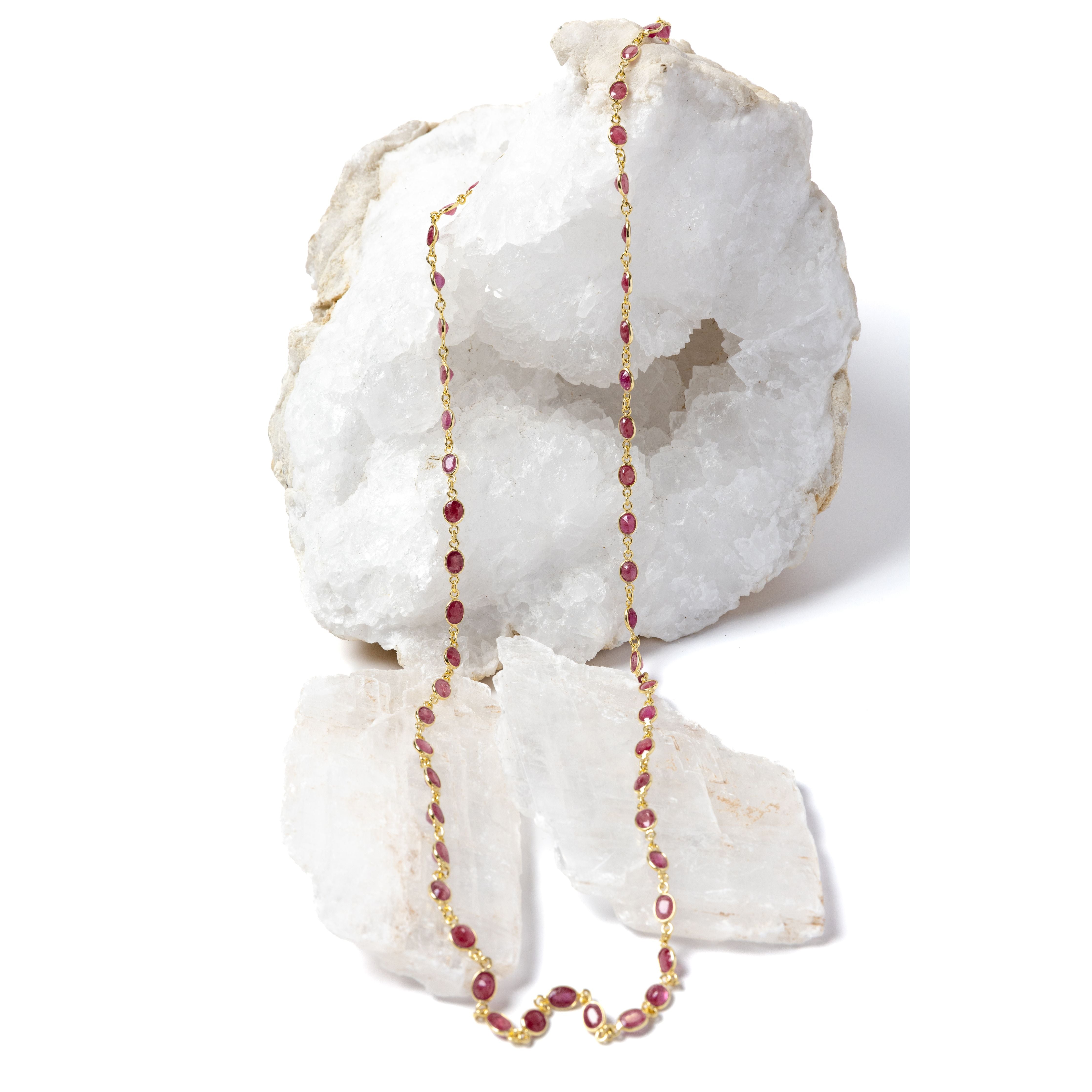 Delicate gold station necklace featuring beautiful cherry-colored rubies set in bezel settings along a fine chain, creating a vibrant, light-catching rhythm.