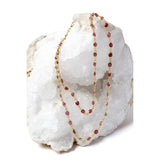 Cherry Bloom gold station necklace with beautiful cherry-colored rubies, styled in two strands to showcase its elegant, layered wear.