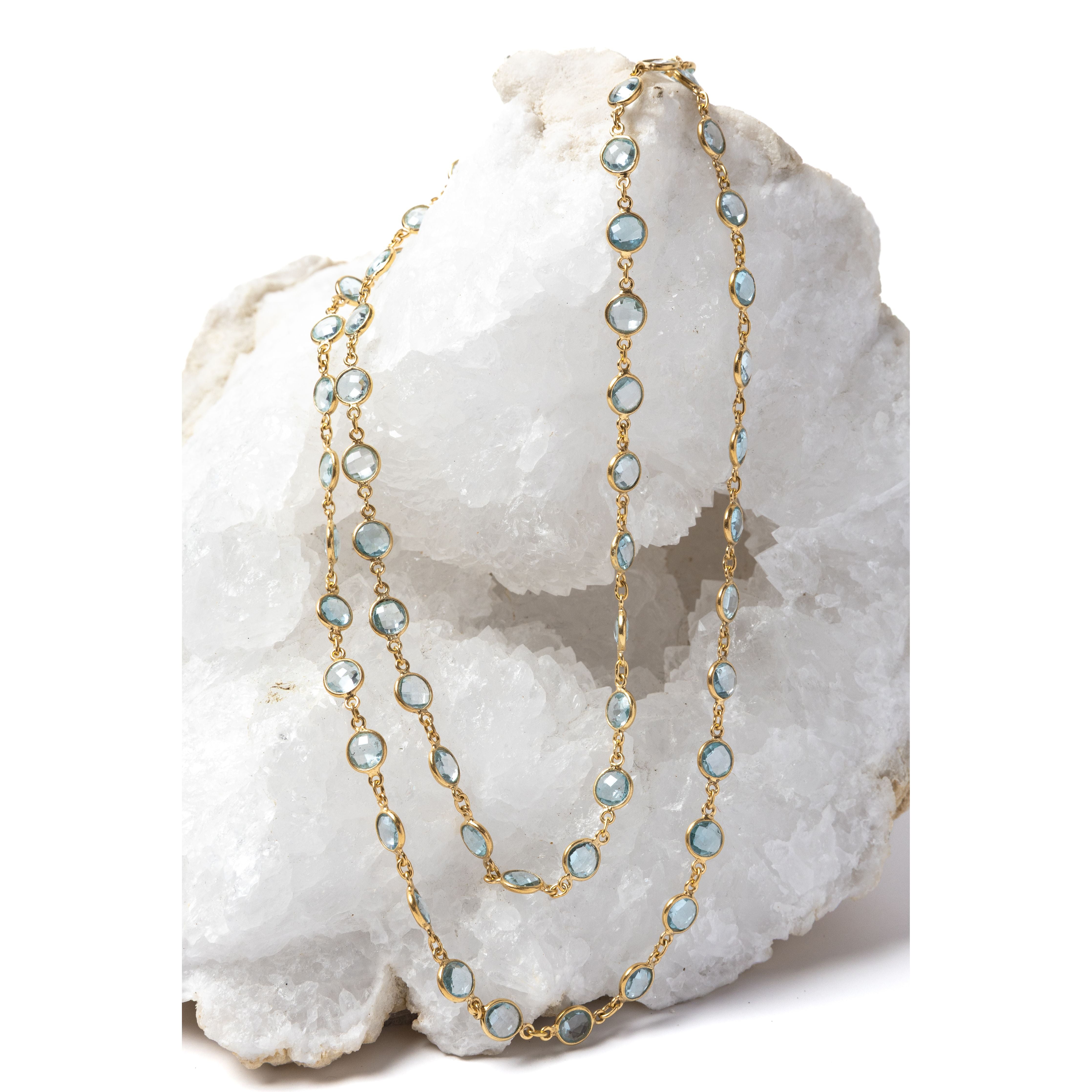 Soft Tide gold necklace featuring blue topaz stones, styled as a double-strand design to highlight its versatile wear.
