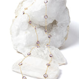 Delicate gold station necklace featuring clear, translucent lavender amethyst stones set along a fine chain, creating a soft, luminous rhythm.