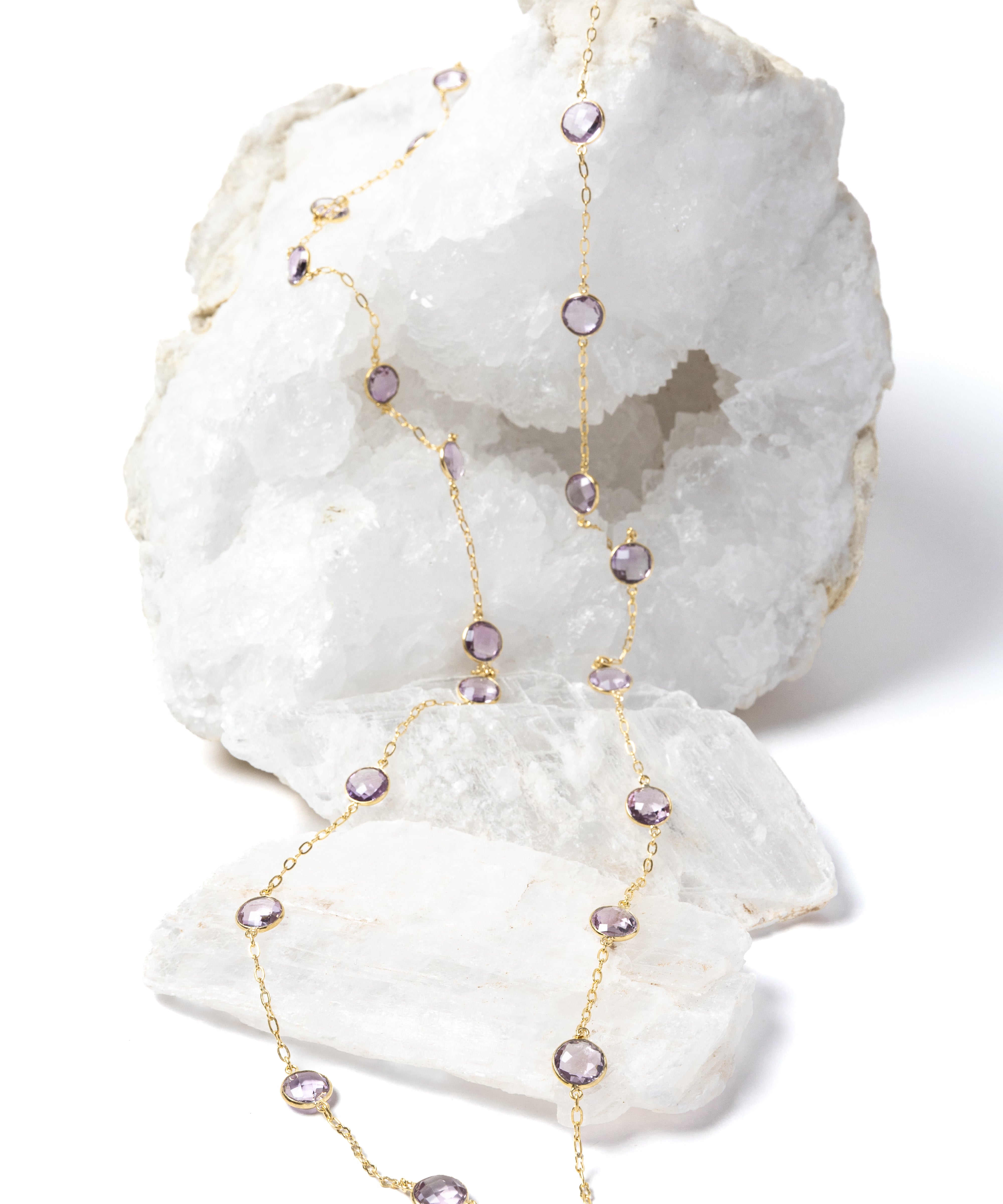 Delicate gold station necklace featuring clear, translucent lavender amethyst stones set along a fine chain, creating a soft, luminous rhythm.