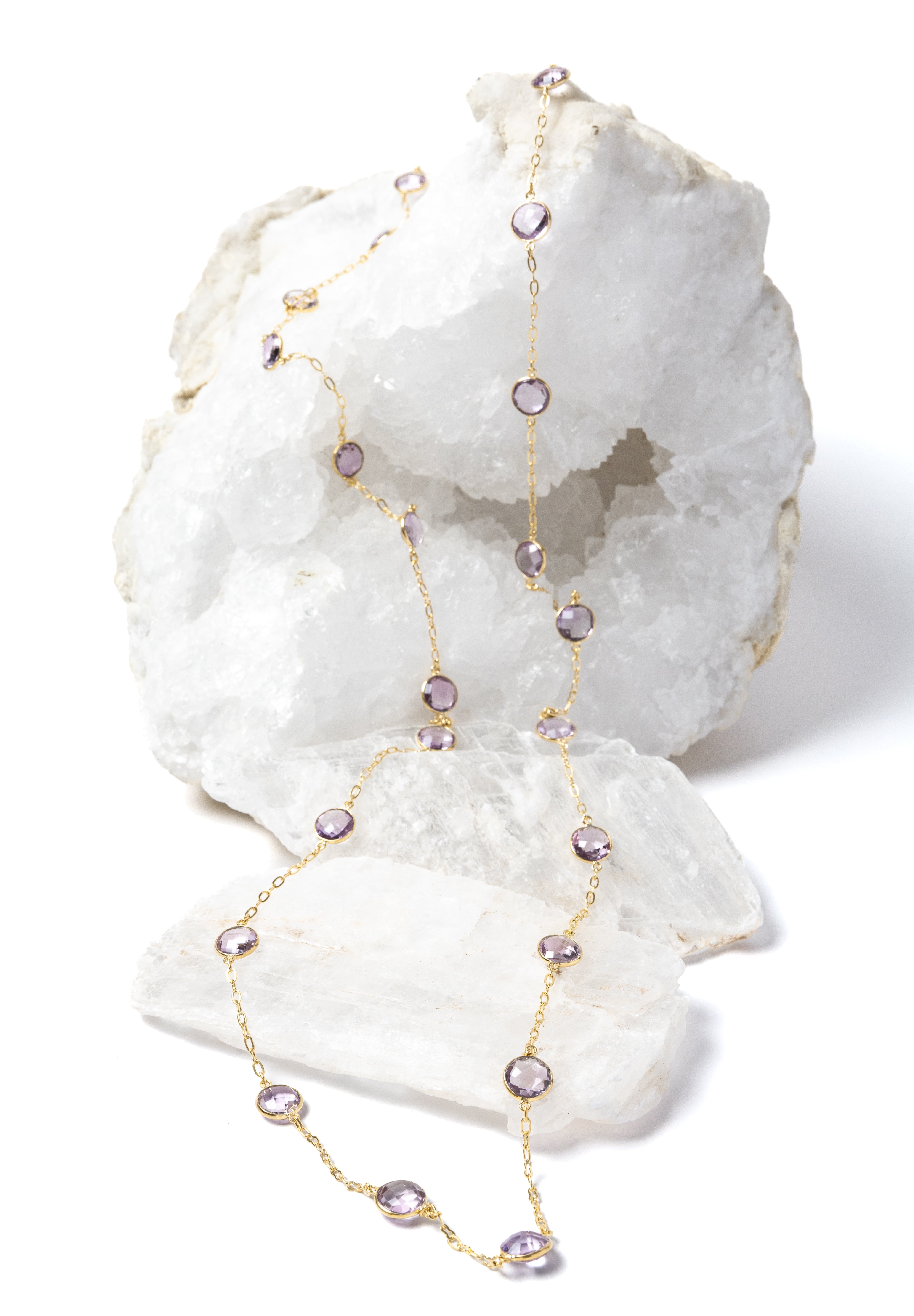 Delicate gold station necklace featuring clear, translucent lavender amethyst stones set along a fine chain, creating a soft, luminous rhythm.