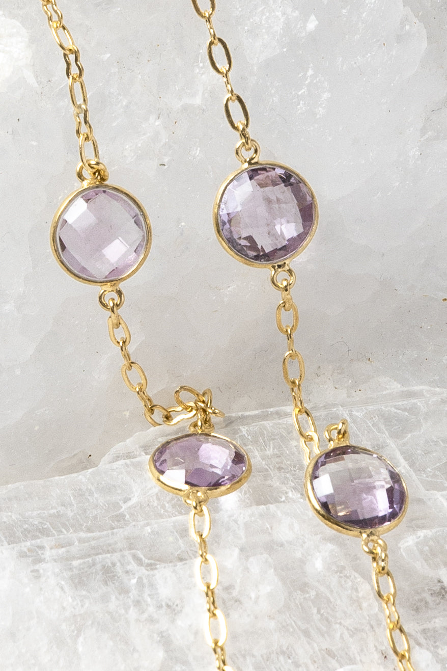 Close-up of the Violet Mist necklace highlighting clear, translucent lavender amethyst stones in bezel settings along a fine gold chain.