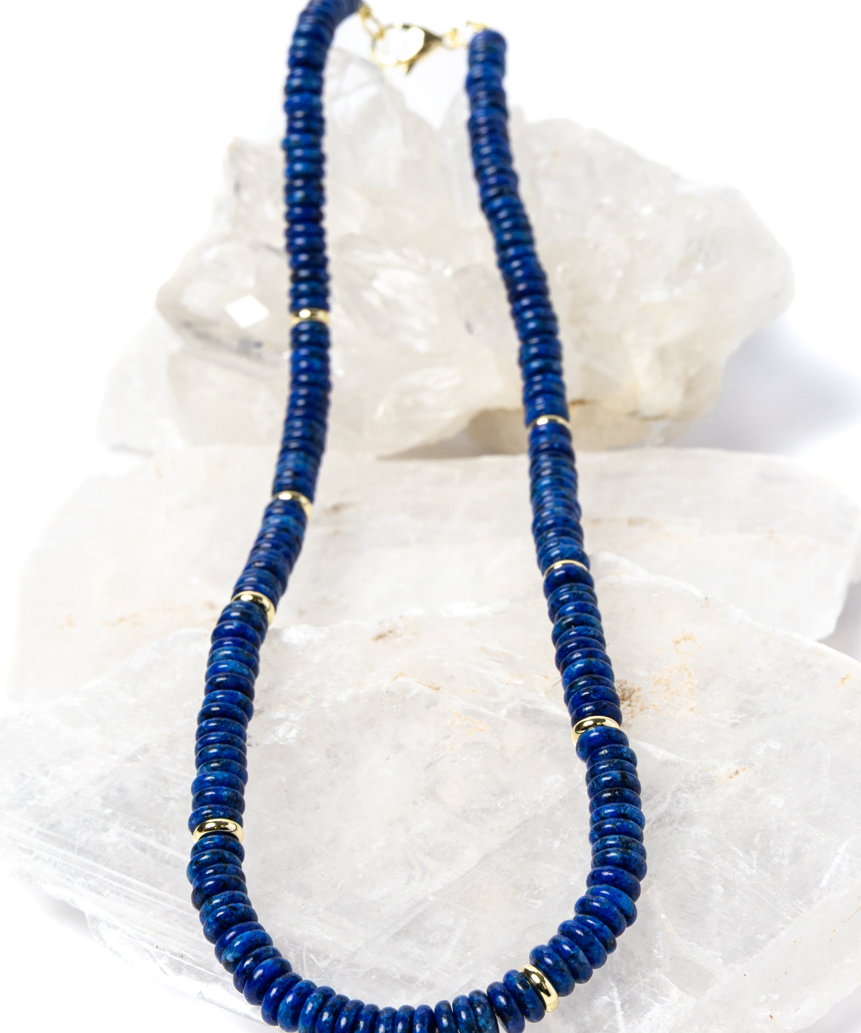 Luxury handcrafted lapis lazuli necklace featuring deep midnight-blue lapis rondelles with polished gold-plated spacer accents and an elegant minimalist silhouette.