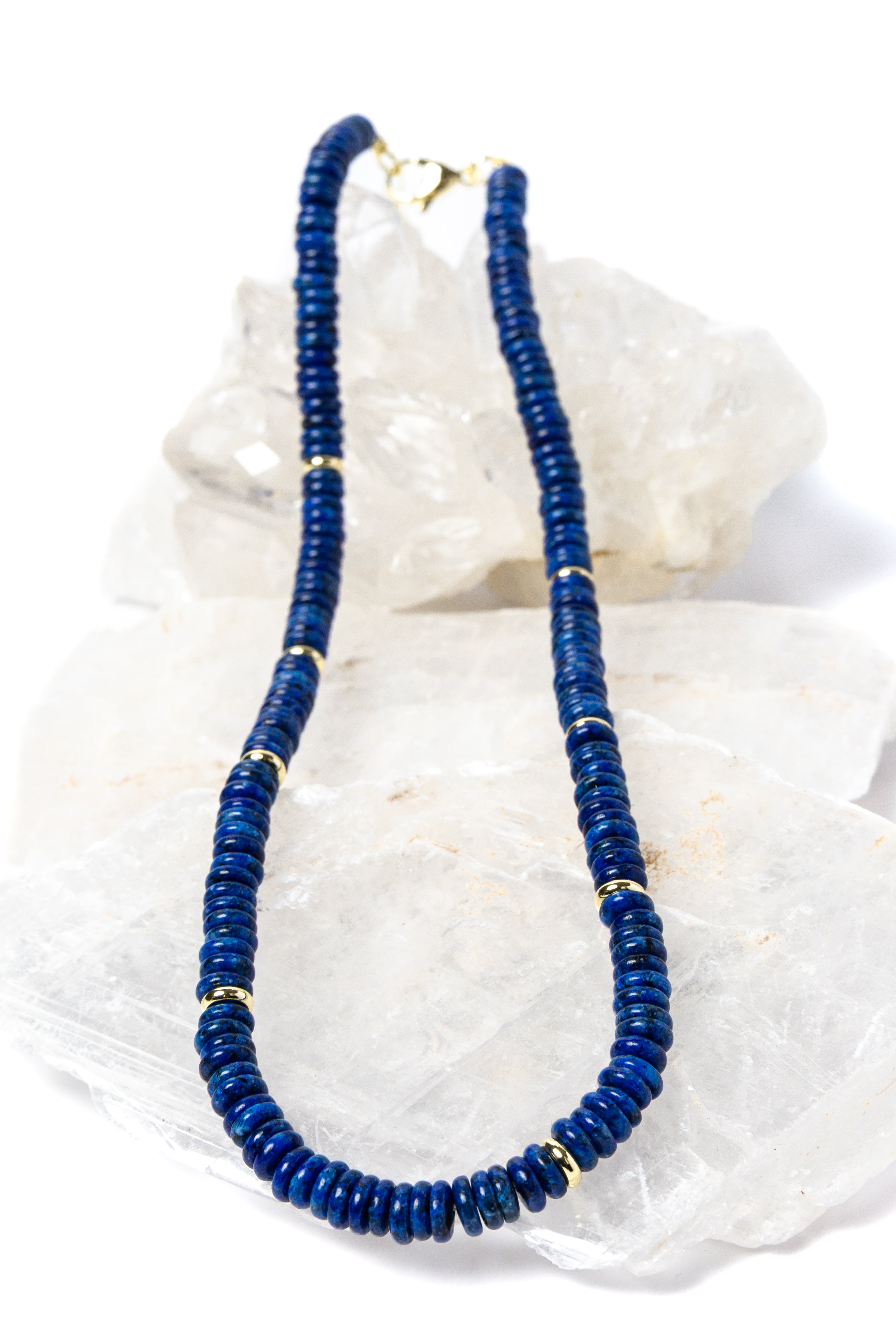 Luxury handcrafted lapis lazuli necklace featuring deep midnight-blue lapis rondelles with polished gold-plated spacer accents and an elegant minimalist silhouette.