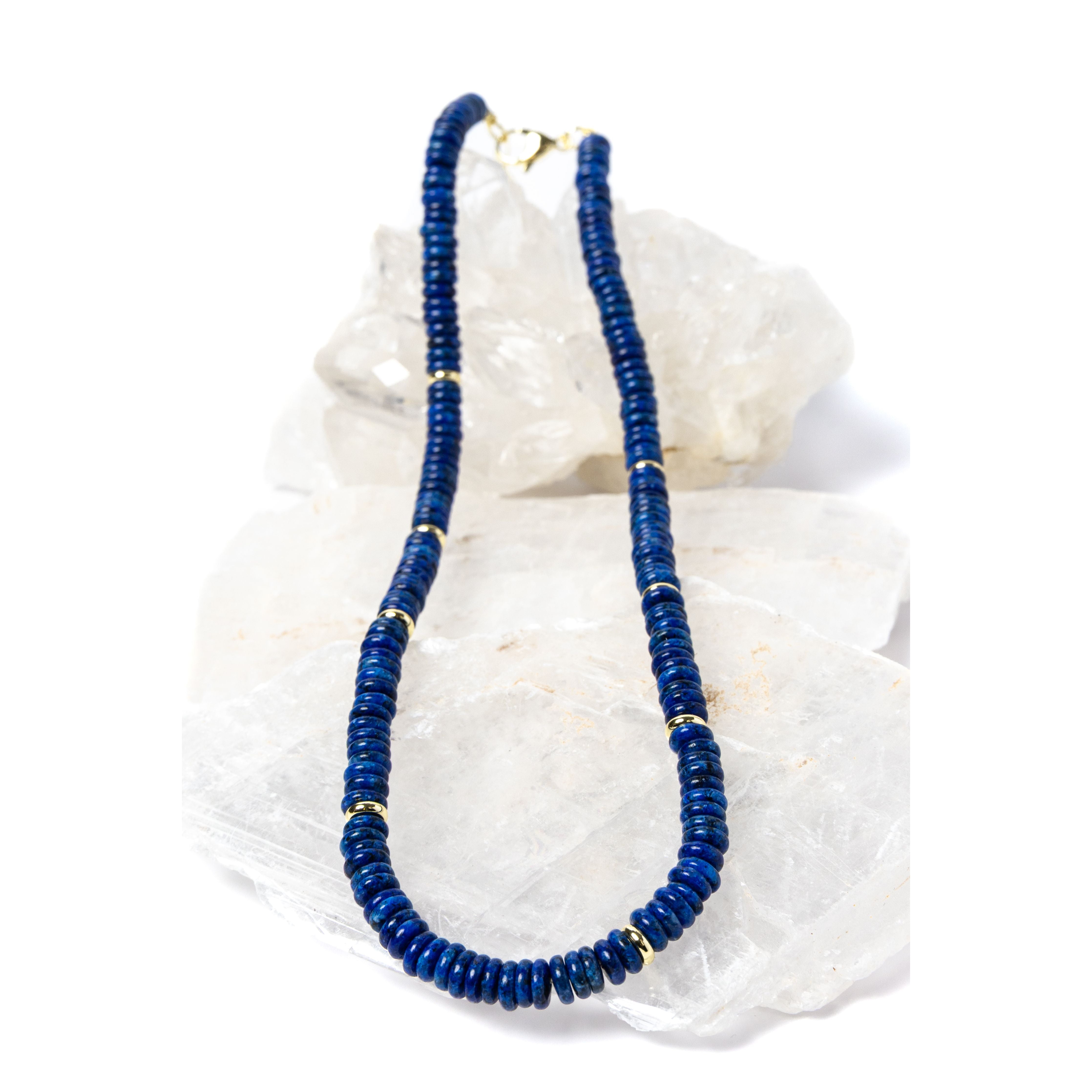Luxury handcrafted lapis lazuli necklace featuring deep midnight-blue lapis rondelles with polished gold-plated spacer accents and an elegant minimalist silhouette.