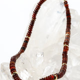 Luxury handcrafted red agate necklace featuring polished red agate rondelles in rich terracotta, rust, and deep crimson tones with gold-plated accent spacers and an elegant minimalist silhouette.