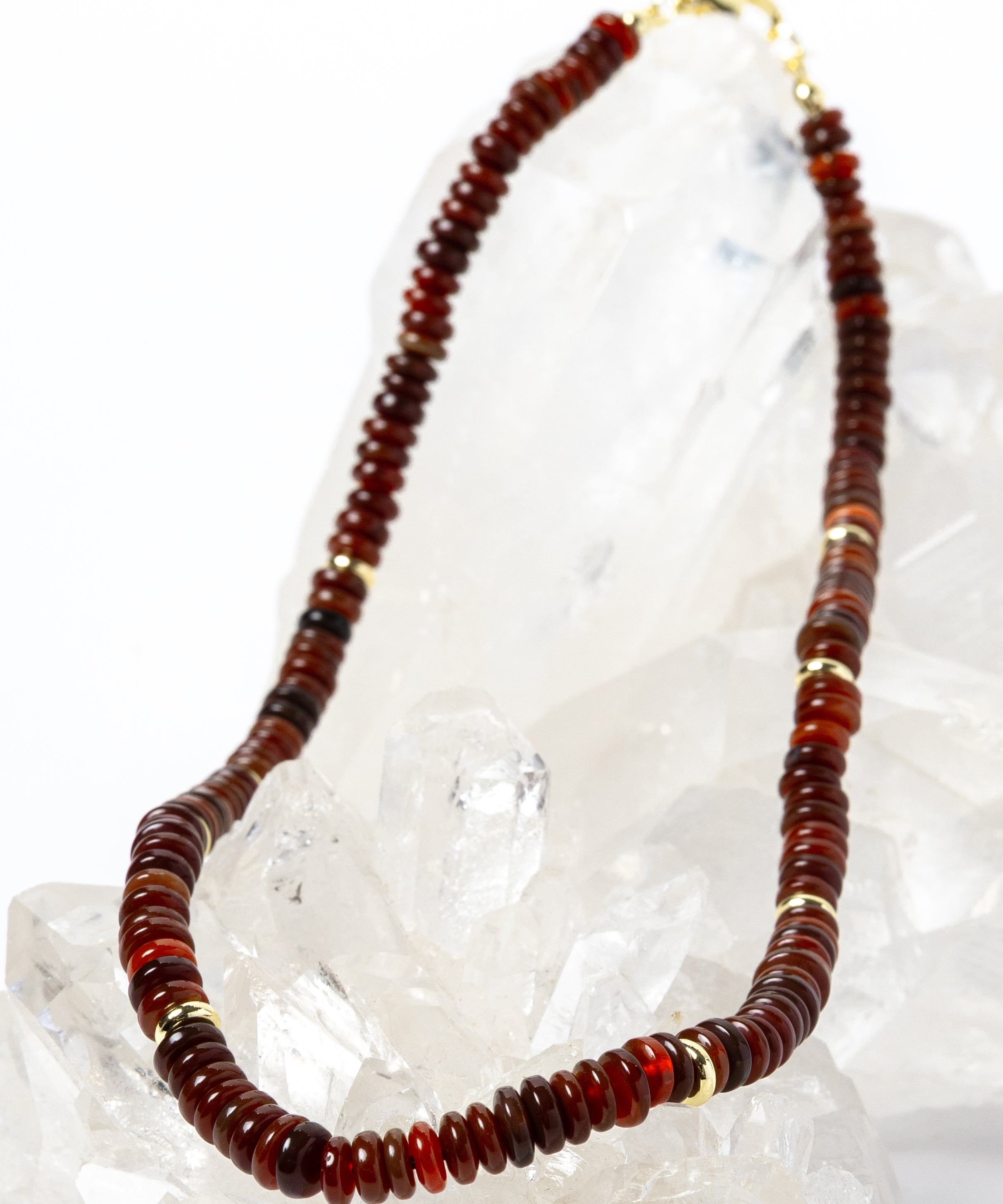 Luxury handcrafted red agate necklace featuring polished red agate rondelles in rich terracotta, rust, and deep crimson tones with gold-plated accent spacers and an elegant minimalist silhouette.