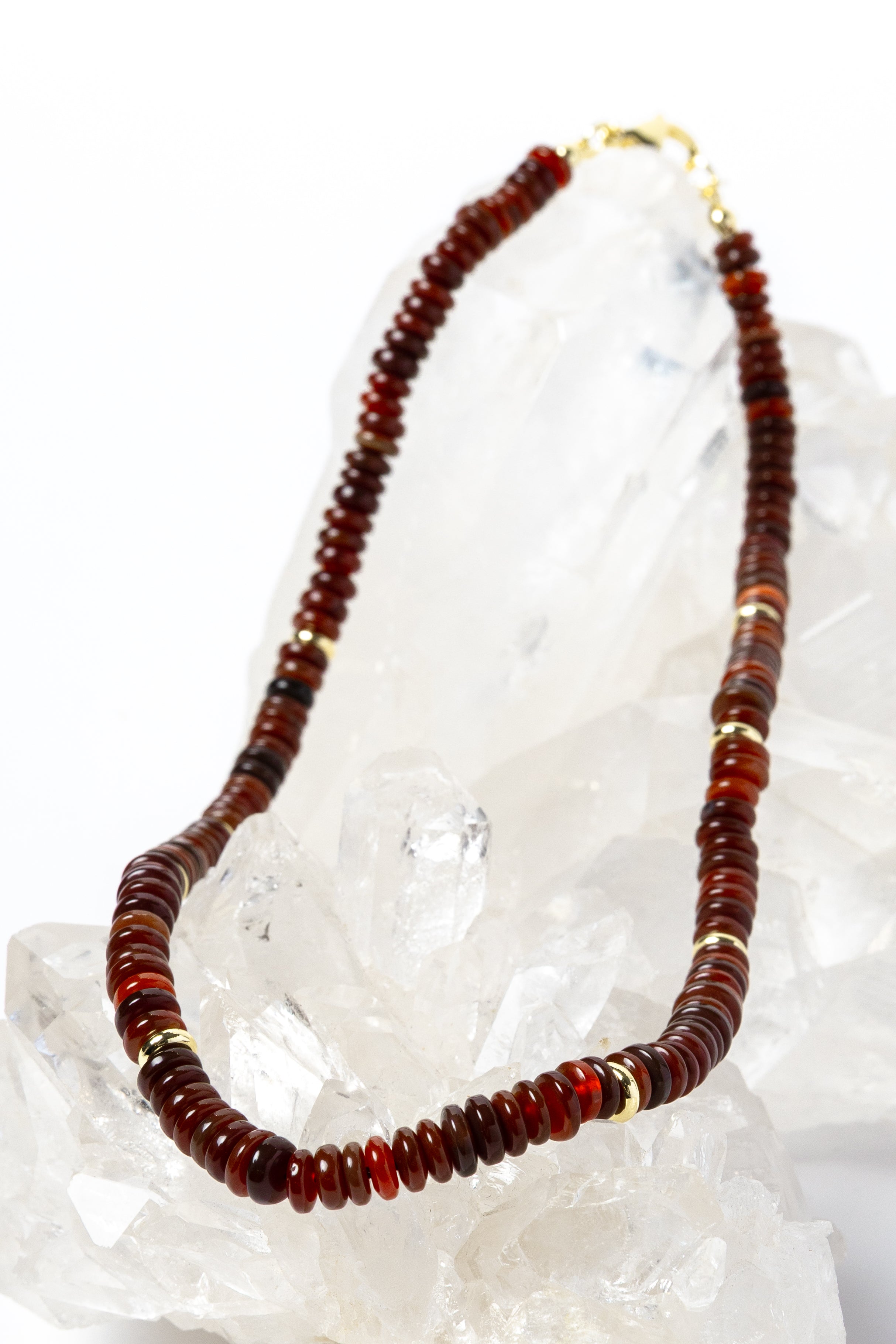 Luxury handcrafted red agate necklace featuring polished red agate rondelles in rich terracotta, rust, and deep crimson tones with gold-plated accent spacers and an elegant minimalist silhouette.