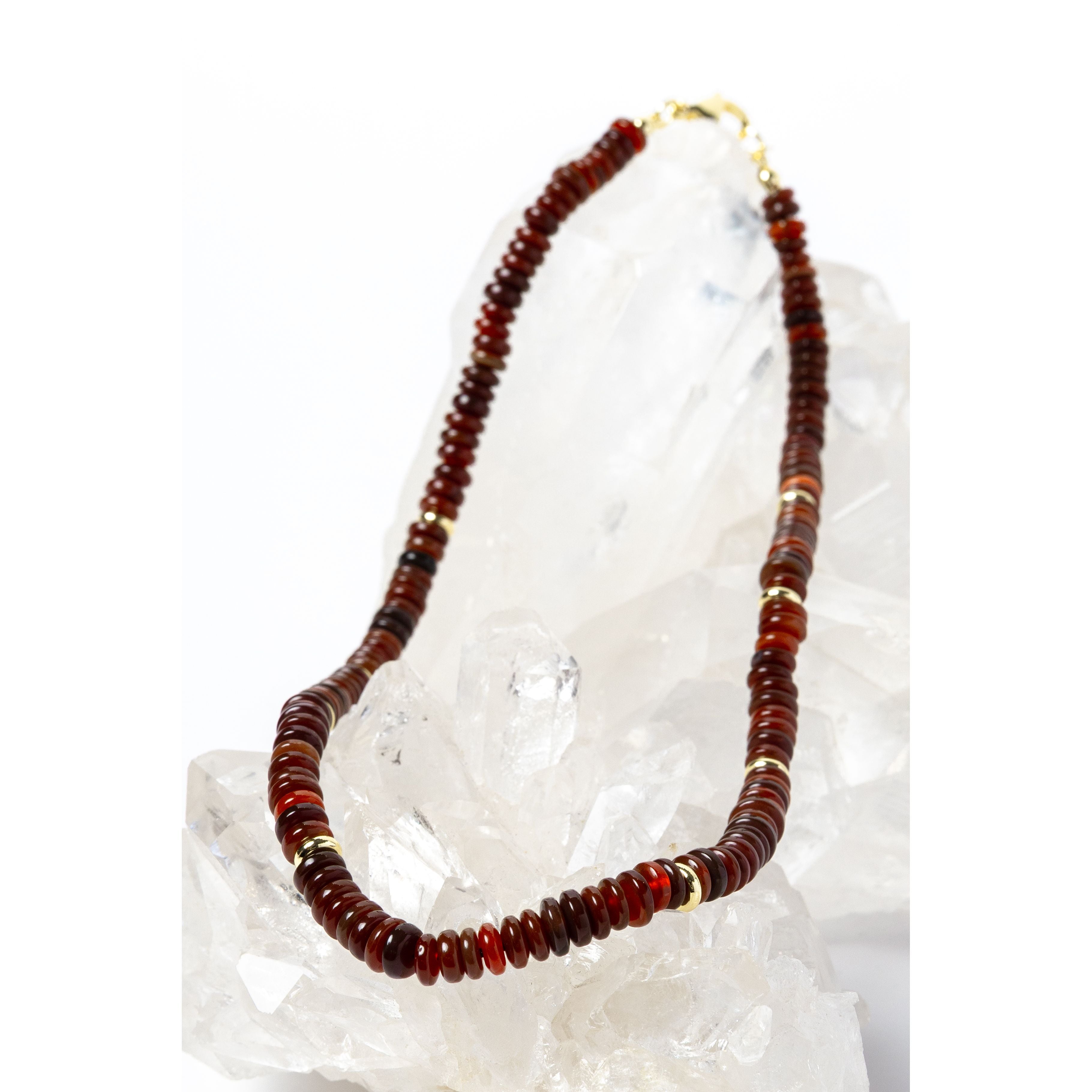 Luxury handcrafted red agate necklace featuring polished red agate rondelles in rich terracotta, rust, and deep crimson tones with gold-plated accent spacers and an elegant minimalist silhouette.