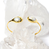 Luxury open cuff bracelet featuring two luminous natural baroque pearls set in polished gold-plated bezels with a refined sculptural silhouette.