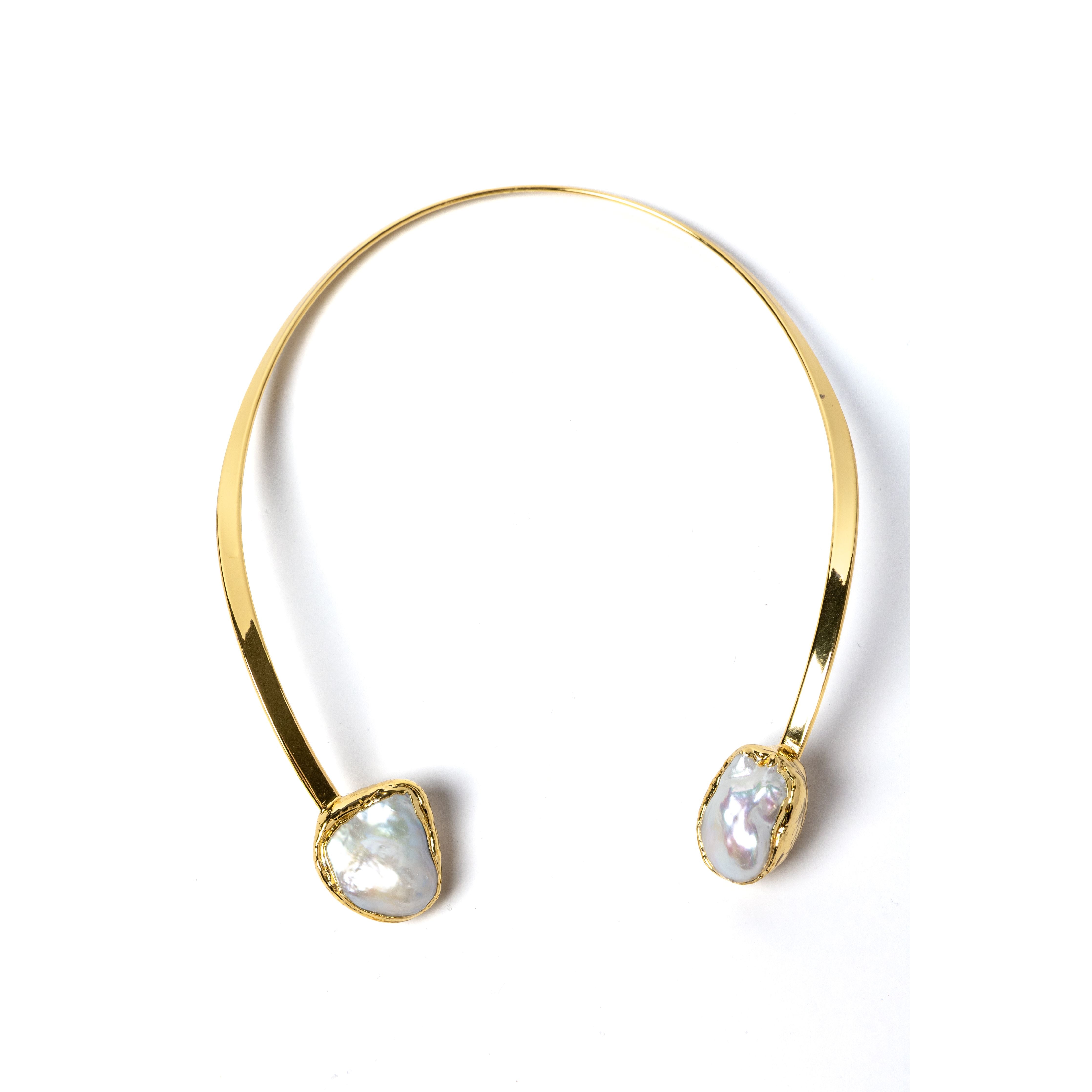 Luxury sculptural open-front collar necklace featuring two substantial natural baroque pearls suspended from a polished gold-plated curved structure with a refined contemporary silhouette.