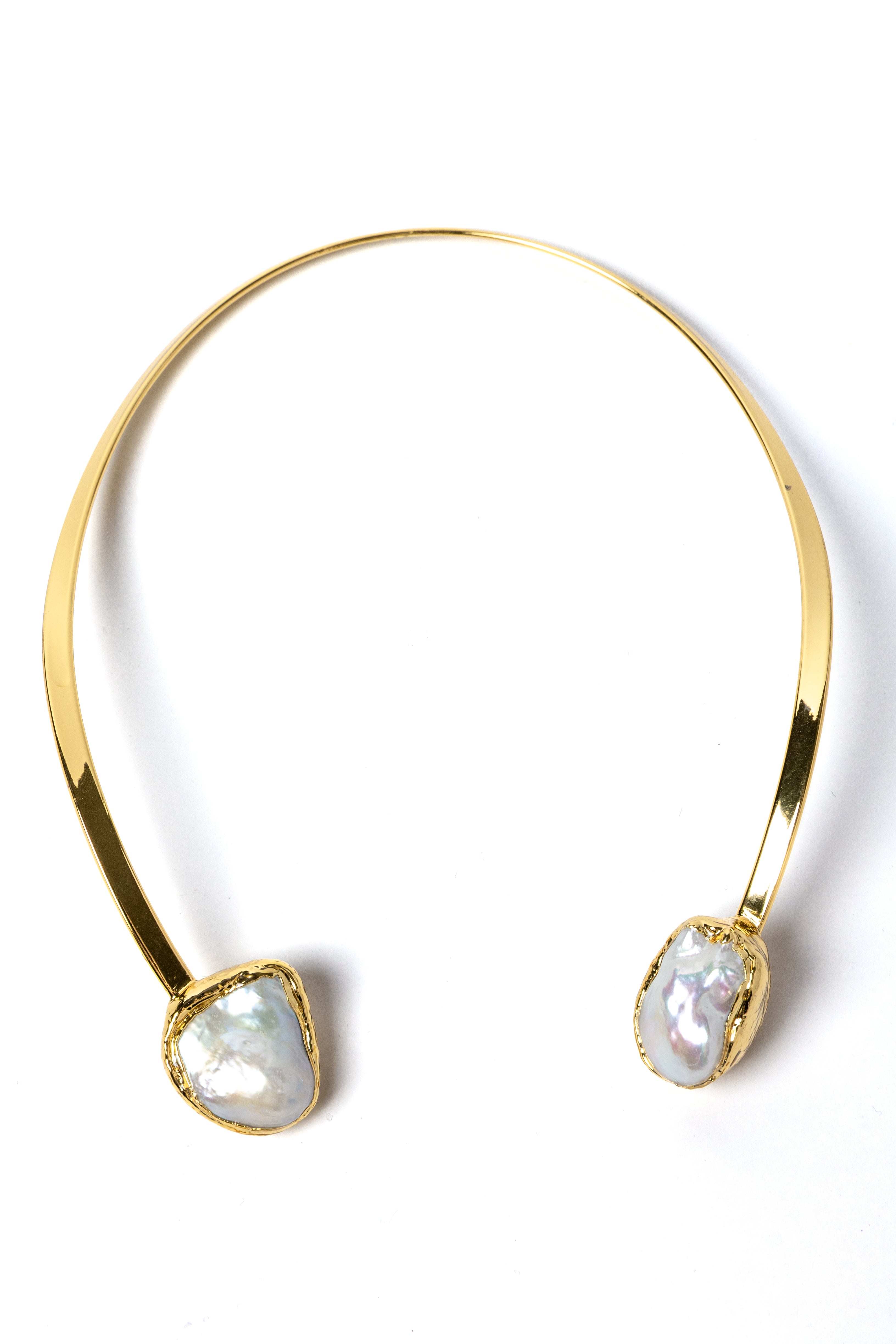 Luxury sculptural open-front collar necklace featuring two substantial natural baroque pearls suspended from a polished gold-plated curved structure with a refined contemporary silhouette.