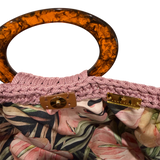Interior of the muted pink Giselle handbag featuring a vivid botanical lining with anthuriums, layered foliage, and magnetic closure.