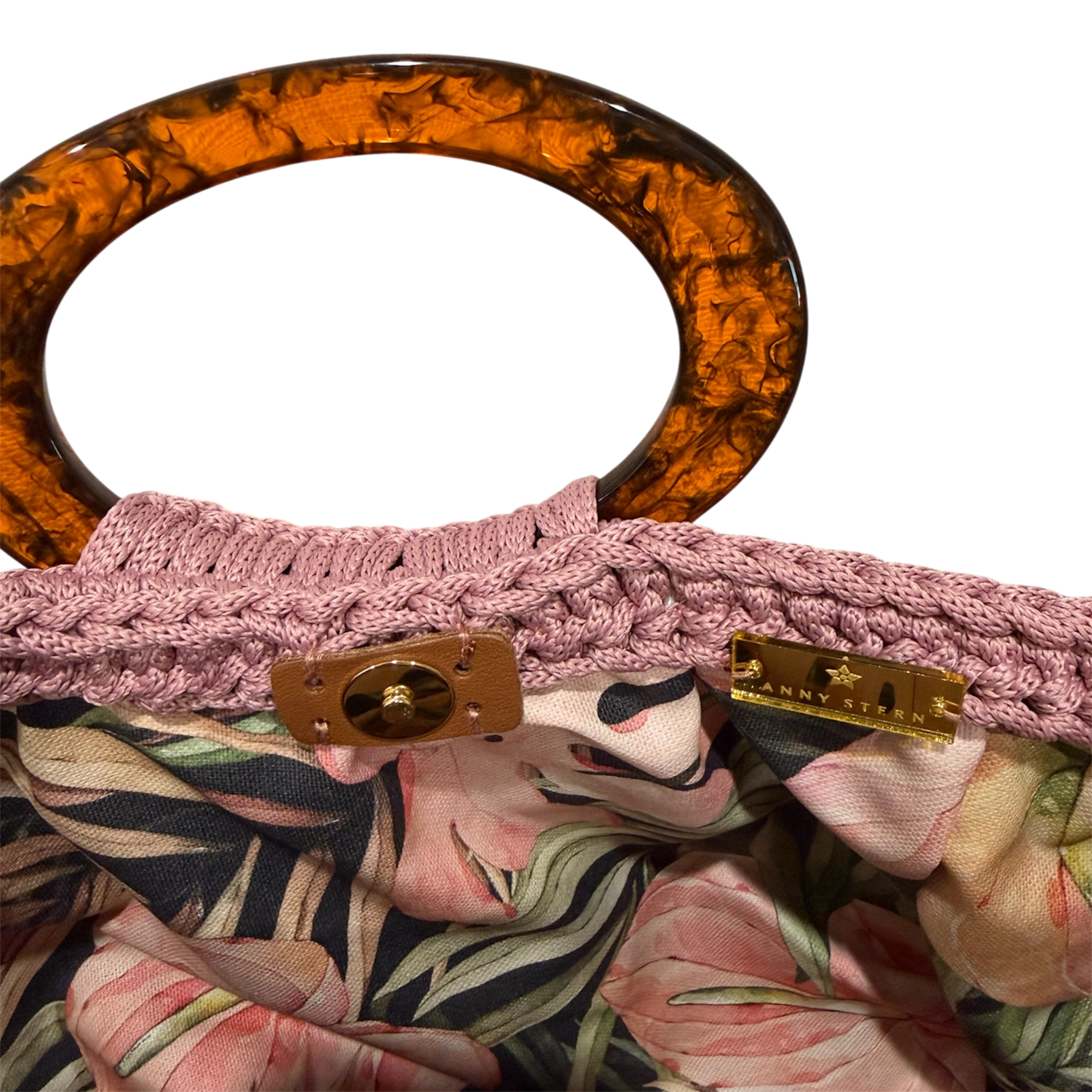 Interior of the muted pink Giselle handbag featuring a vivid botanical lining with anthuriums, layered foliage, and magnetic closure.