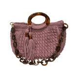Muted pink hand-crocheted Giselle handbag with dark marbled resin handle, coordinating resin chain, tassel detail, and softly structured silhouette.