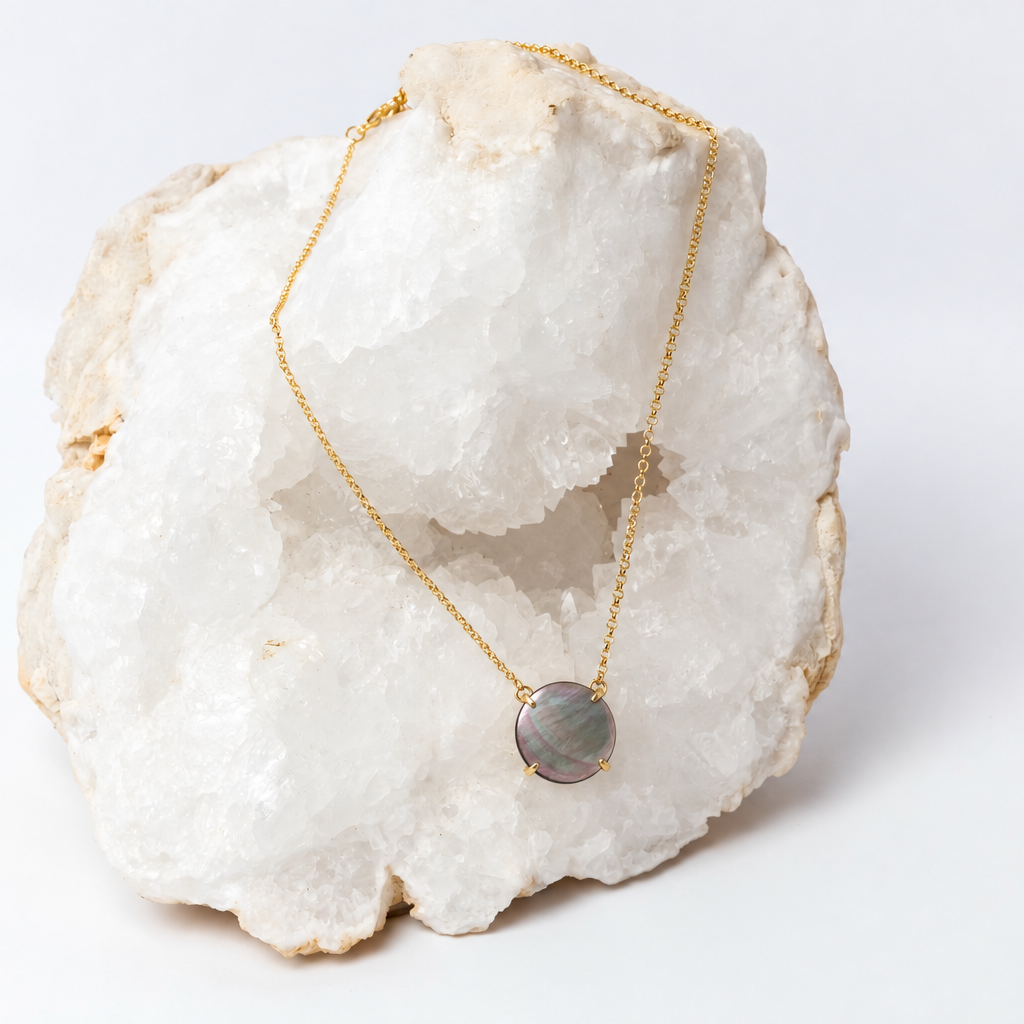 Delicate yellow-gold necklace with a flat, polished round abalone pendant in a four-prong setting.