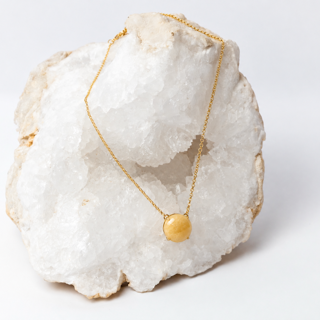 Round honey-yellow aragonite cabochon necklace on a delicate 18k gold-plated chain.