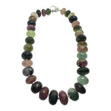 Luxury handcrafted rainbow tourmaline necklace featuring large faceted multicolor tourmaline rondelles with rich natural tones and a bold statement silhouette.
