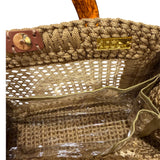 Interior view of the Amélie · Sandstone handbag featuring a dimensional caramel crochet frame, woven rattan center structure, gold-tone hardware, magnetic closure, and discreet transparent insert pocket within the unlined sculptural silhouette.