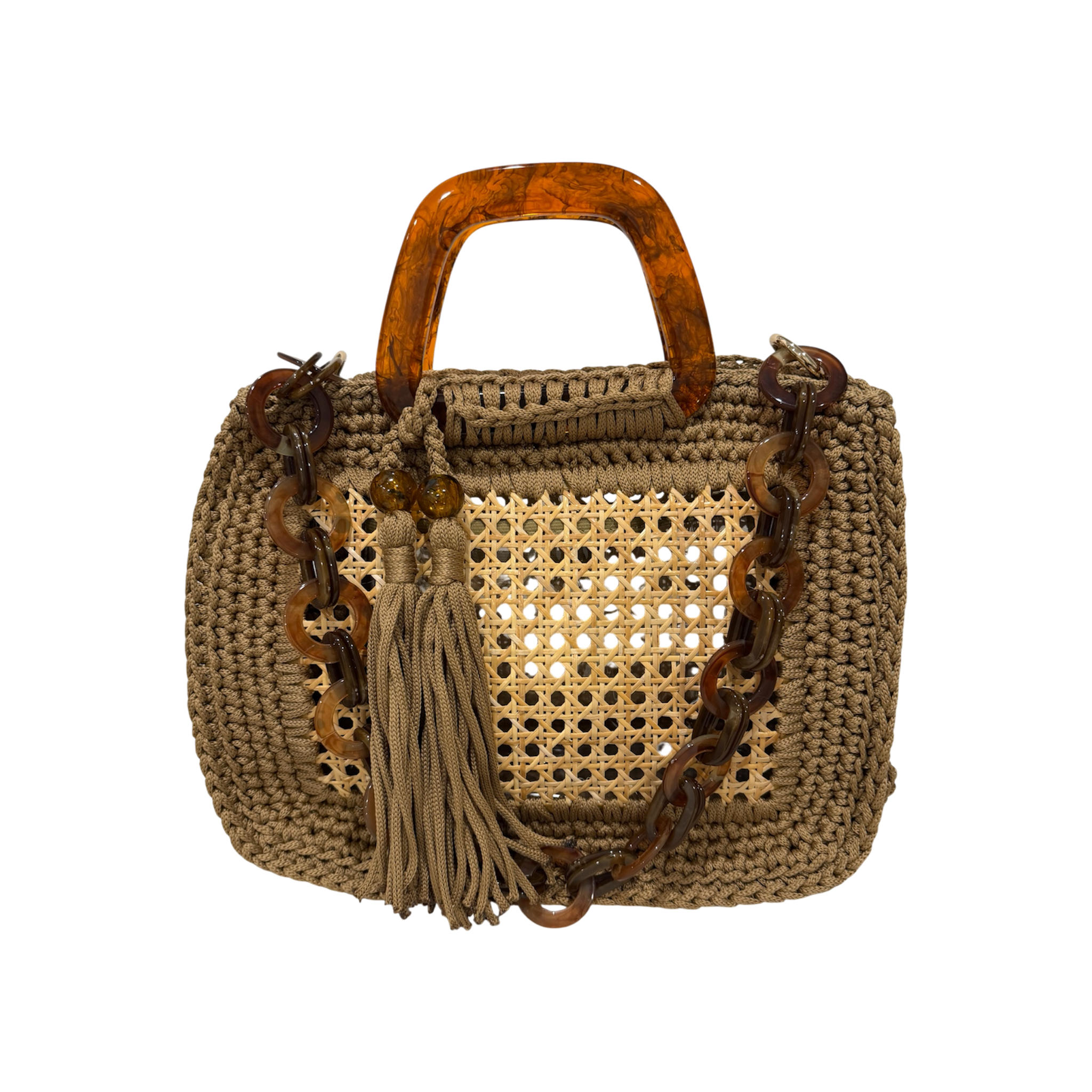 Caramel handcrafted luxury handbag with architectural woven rattan center, dimensional crochet frame, marbled resin handles, sculptural chain strap, and tassel detail. The unlined open silhouette includes a discreet transparent insert pocket and a refined compact structure displayed against a neutral background.