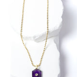 Natural Amethyst Gem Charm Necklace featuring a faceted violet-purple gemstone pendant with a cubic zirconia accent suspended from a gold-plated beaded chain