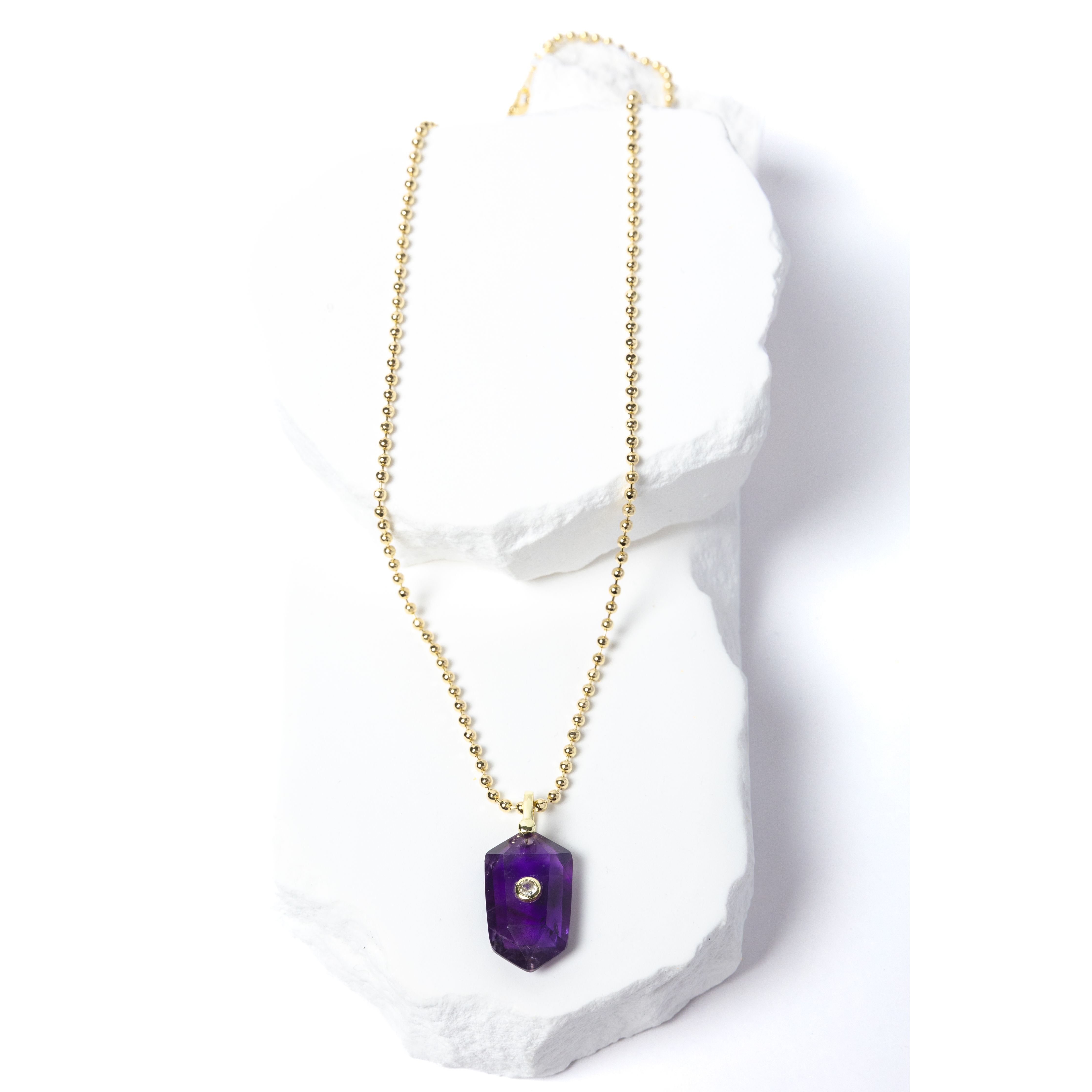 Natural Amethyst Gem Charm Necklace featuring a faceted violet-purple gemstone pendant with a cubic zirconia accent suspended from a gold-plated beaded chain