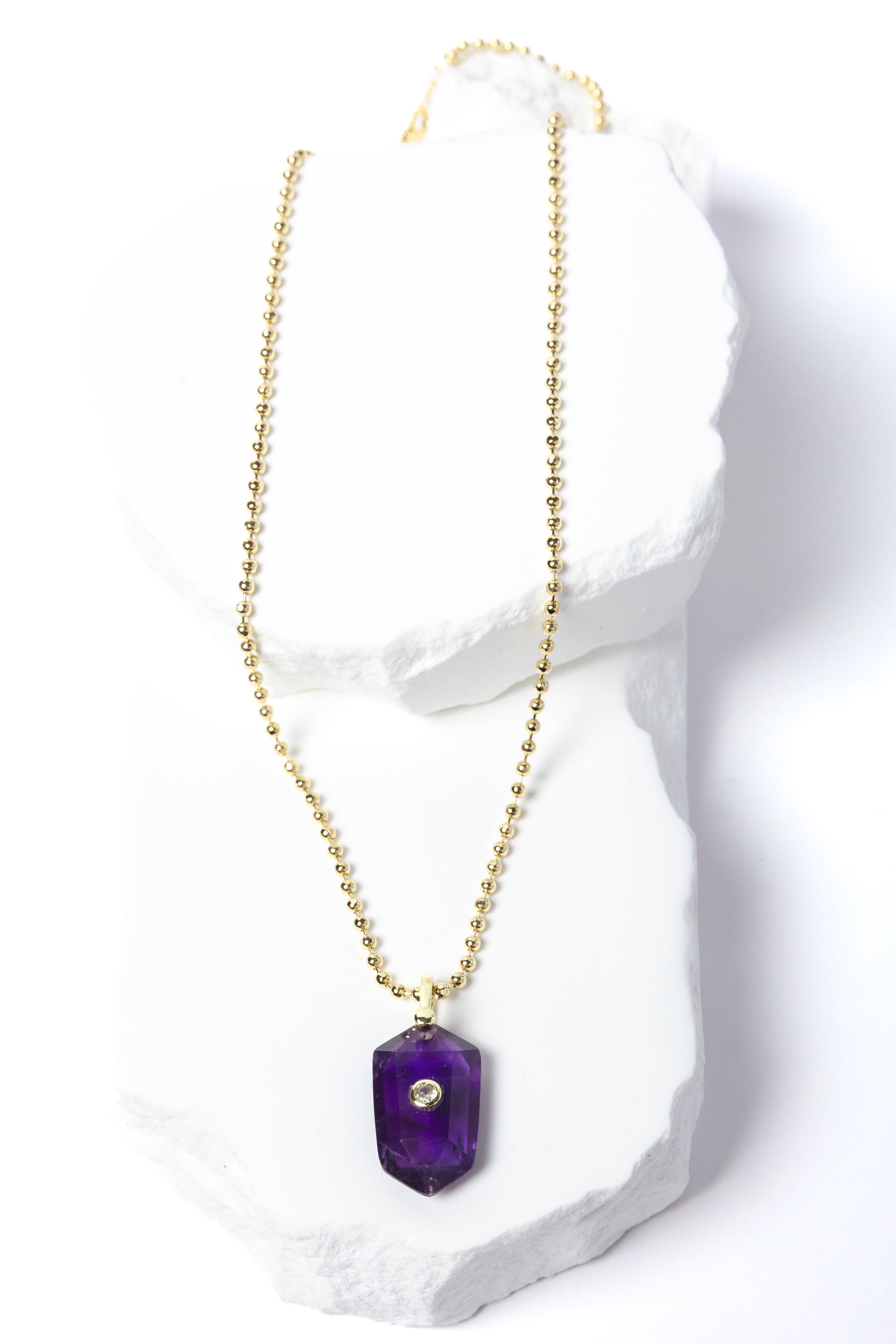 Natural Amethyst Gem Charm Necklace featuring a faceted violet-purple gemstone pendant with a cubic zirconia accent suspended from a gold-plated beaded chain