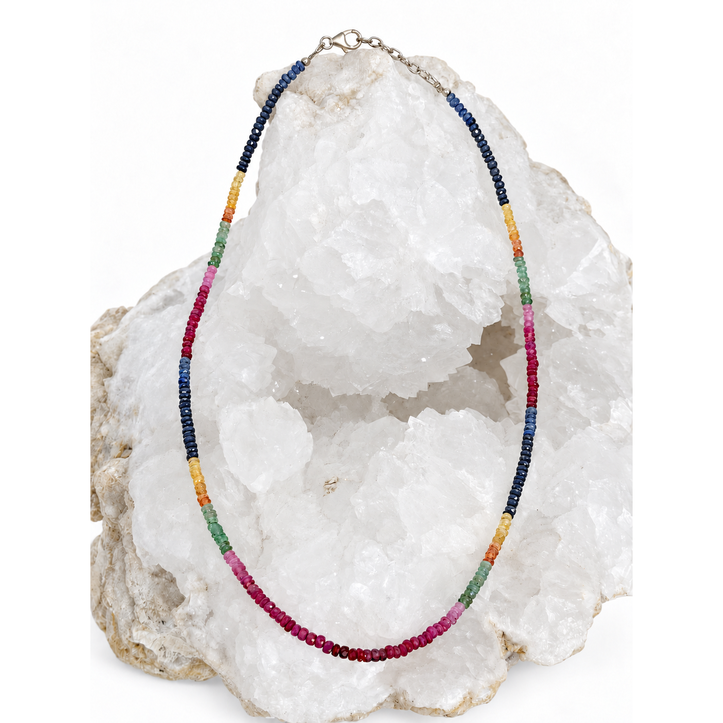 Aurora Mosaic Necklace featuring natural blue and yellow sapphires, emeralds and rubies graduating through light and deep shades, with a sterling silver clasp and 2-inch extension.
