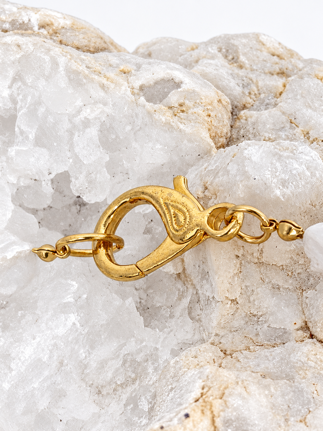 Detail of the decorative gold-plated brass clasp on the baroque pearl and green agate necklace.