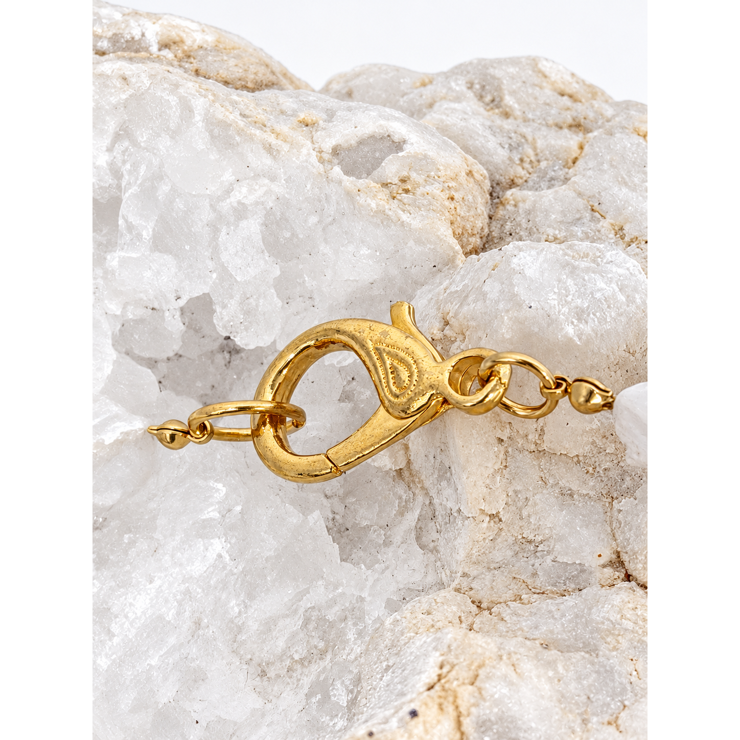 Detail of the decorative gold-plated brass clasp on the baroque pearl and green agate necklace.
