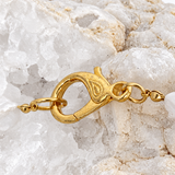 Detail of the decorative gold-plated brass clasp on the baroque pearl and green agate necklace.
