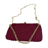 Magenta hand-crocheted Bertha clutch featuring a gold-tone tiger clasp, interchangeable gold chain, and refined rectangular silhouette.