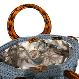 Interior of Blue Bloom handbag with soft floral lining in neutral tones and magnetic closure