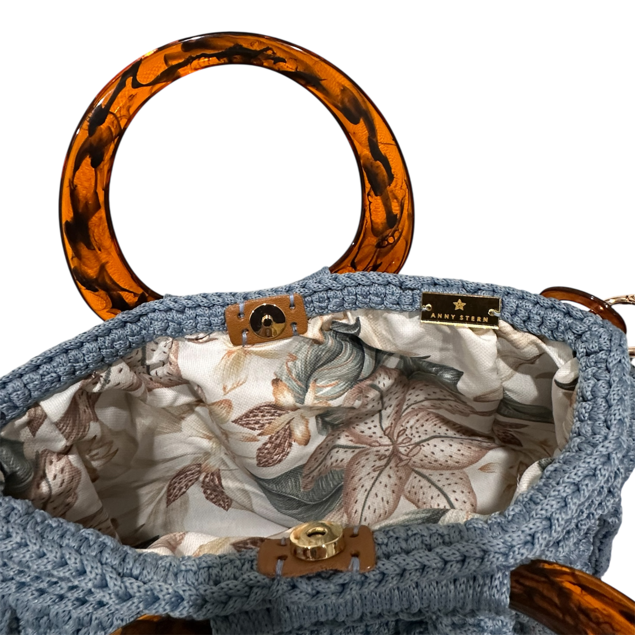 Interior of Blue Bloom handbag with soft floral lining in neutral tones and magnetic closure