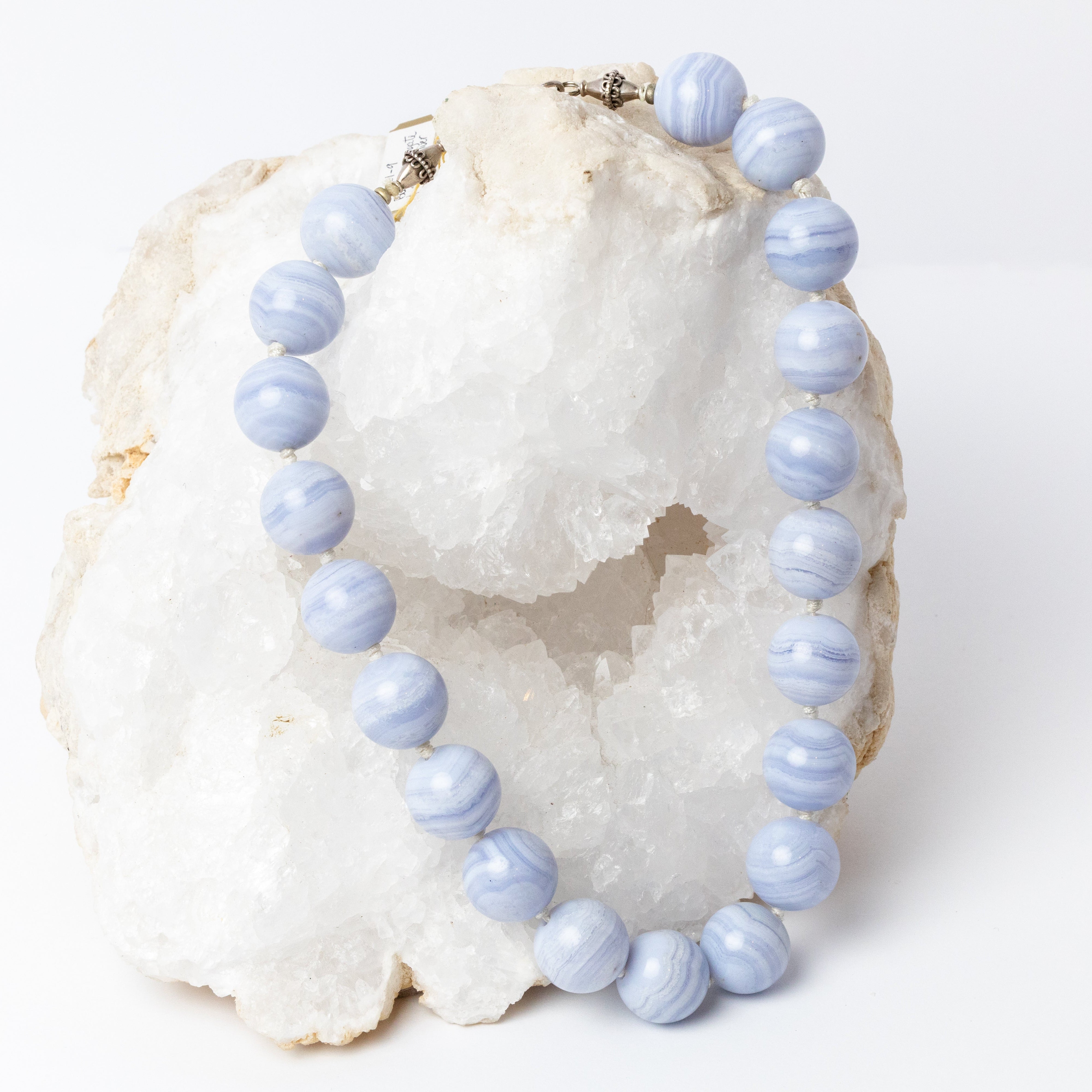 Blue lace agate statement necklace with large round stones, soft blue and white banding, individual knots, and a sterling silver clasp.