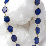 Natural lapis lazuli statement necklace featuring faceted royal-blue gemstones with natural pyrite inclusions set in vermeil bezels.