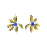 Handcrafted floral earrings featuring blue onyx cabochons and 18k gold plated petals on a soft white background.