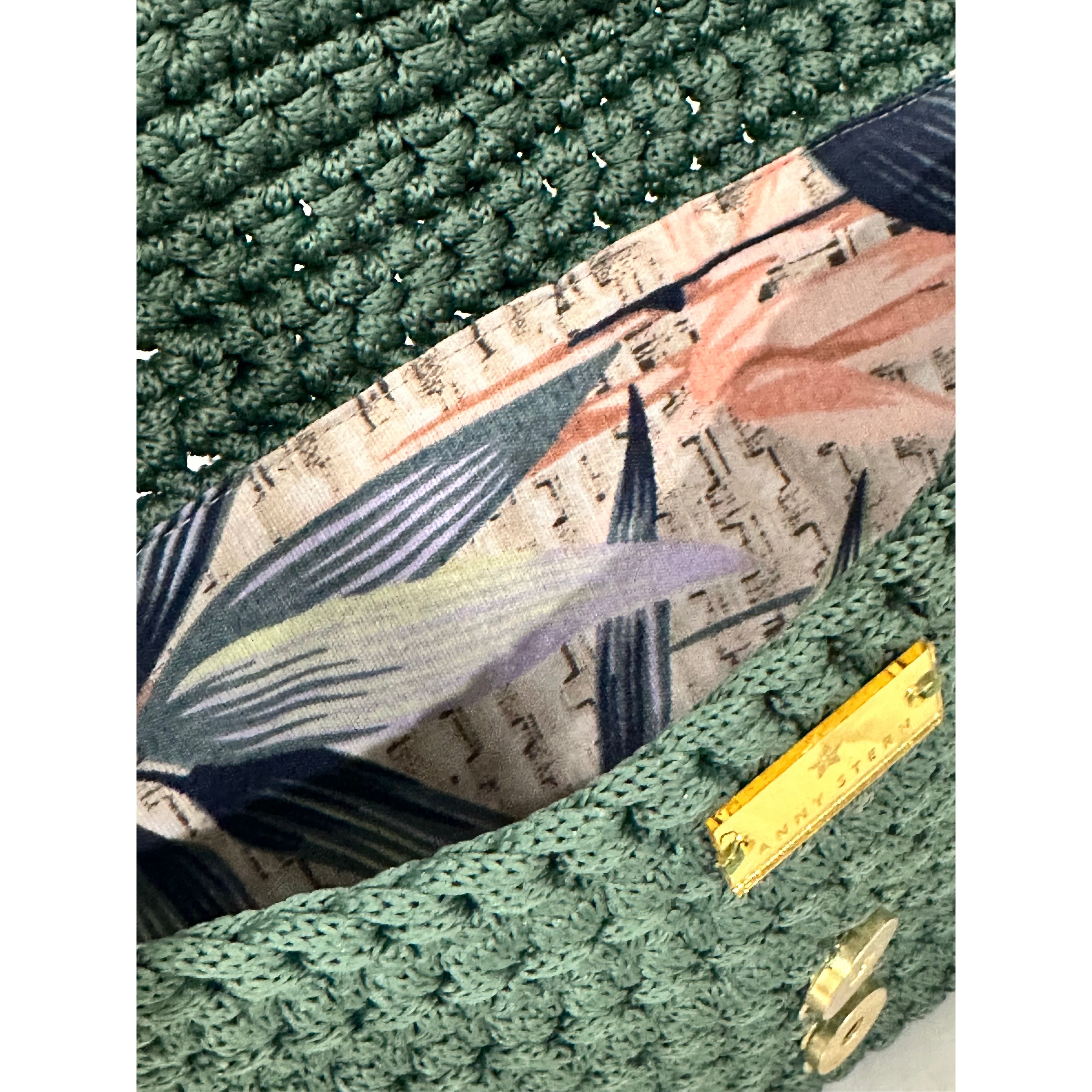 Tropical botanical lining inside the Camille Clutch Birds of Paradise featuring birds of paradise flowers, lush foliage, and handcrafted crochet construction