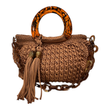 Giselle Terraburly handbag, hand-crocheted luxury bag in rich earthy brown tone with sculptural resin handle, intricate crochet texture, flowing tassel and chain strap
