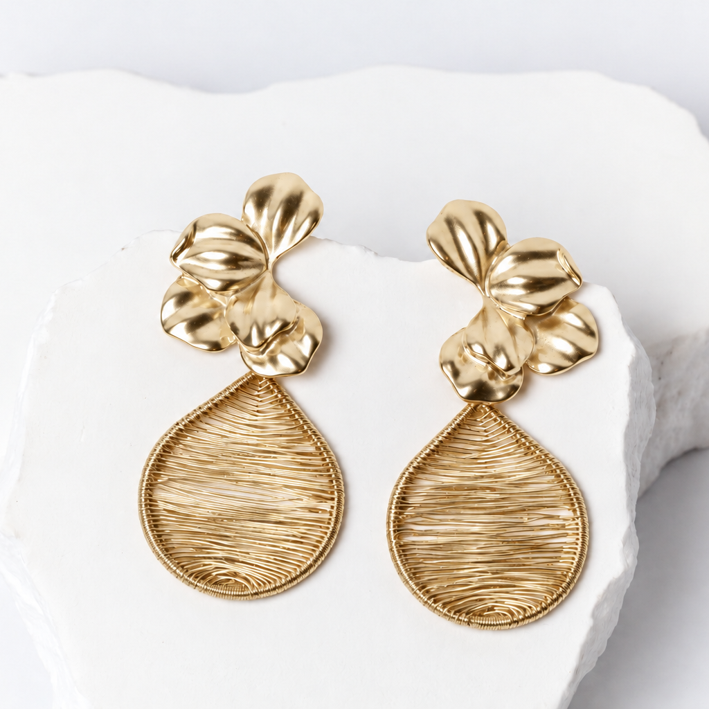 Fiore d’Oro long gold-tone earrings featuring sculptural flowers with rounded petals and intricate hand-woven openwork teardrop drops.
