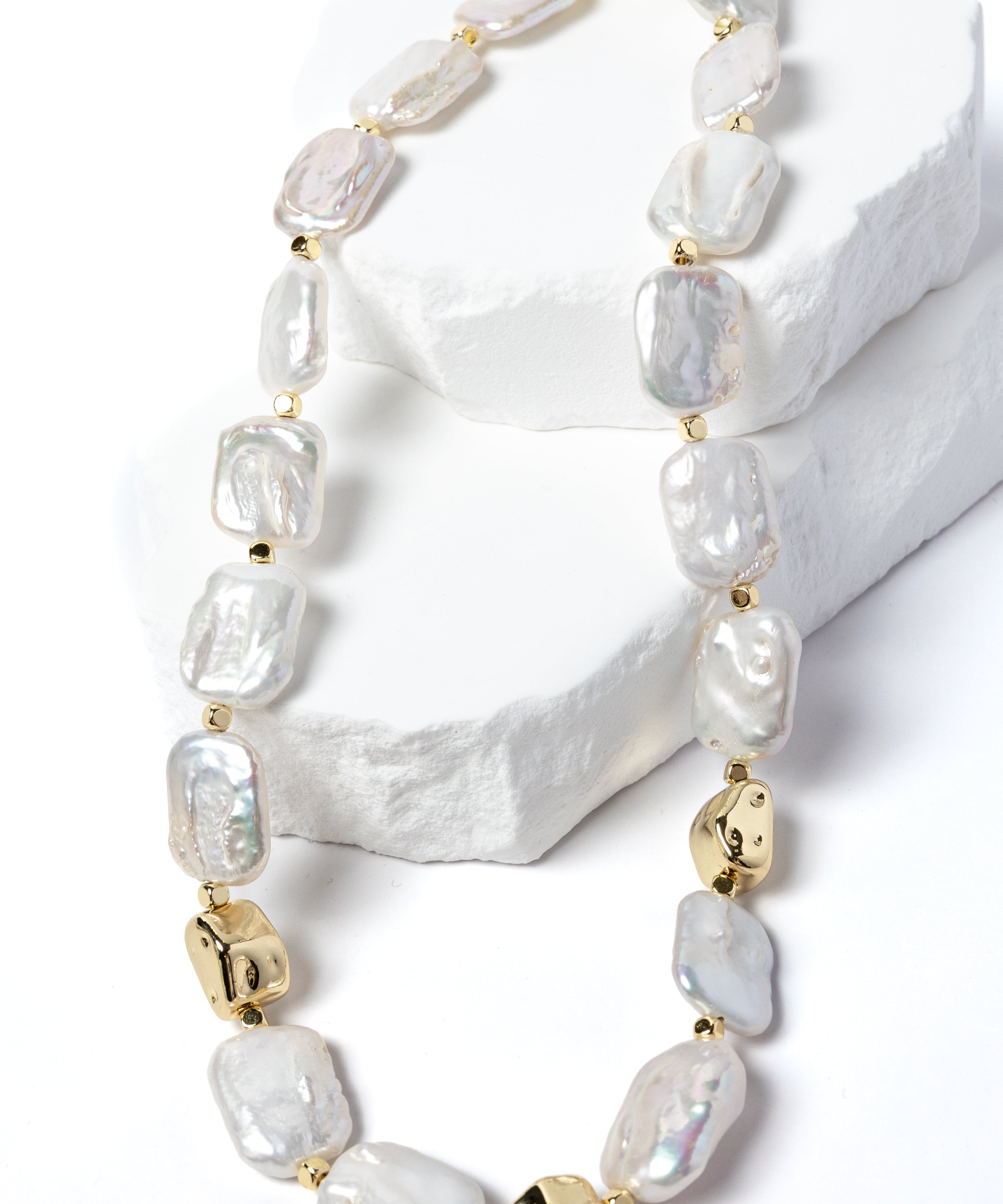 Luxury flat baroque freshwater pearl necklace featuring high-luster organically shaped pearls, gold-plated accents, and an elegant timeless design.