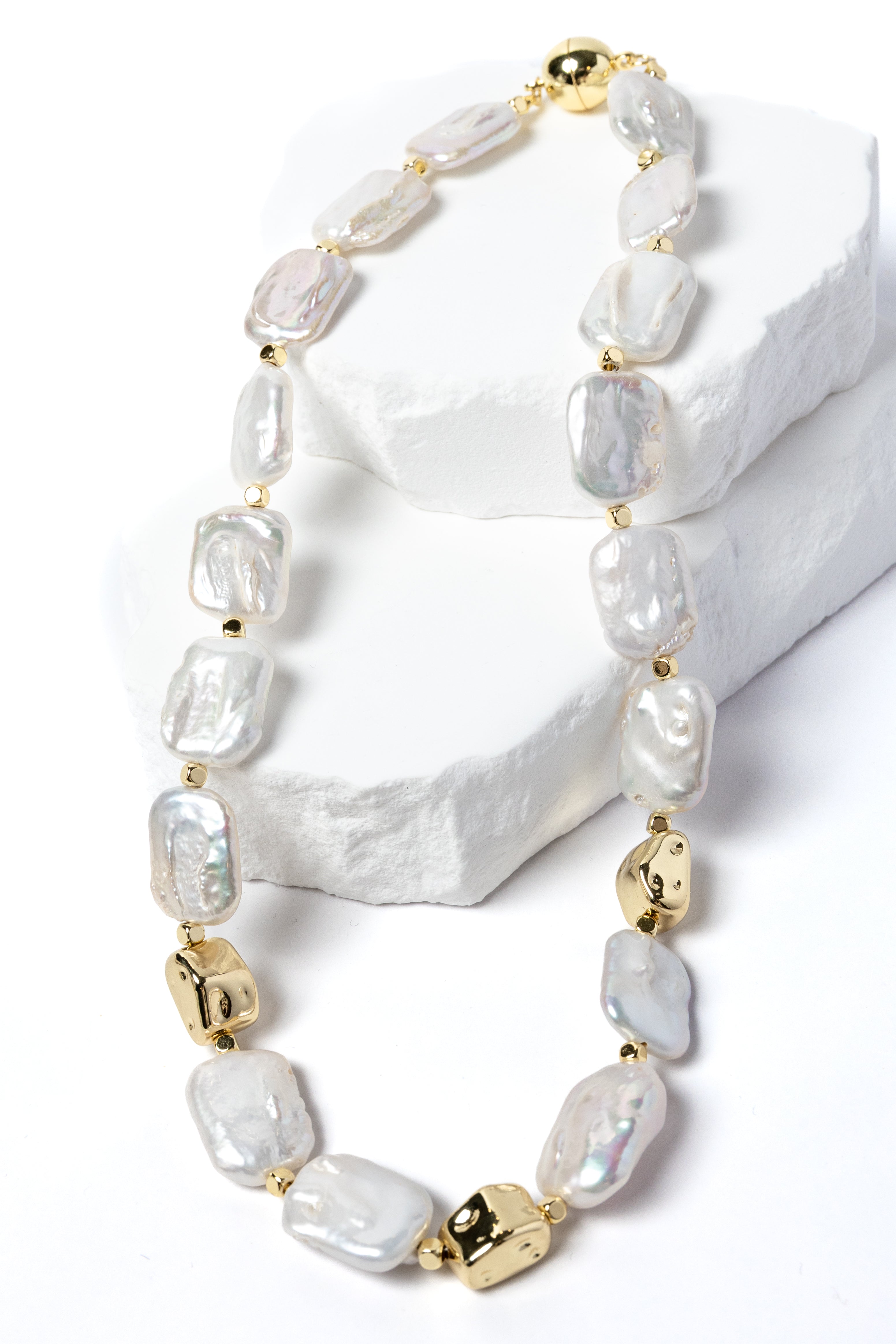 Luxury flat baroque freshwater pearl necklace featuring high-luster organically shaped pearls, gold-plated accents, and an elegant timeless design.