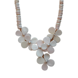 Close-up of the Flor del Mar necklace showcasing handcrafted floral motifs created from natural blush conch shell with freshwater pearl accents.